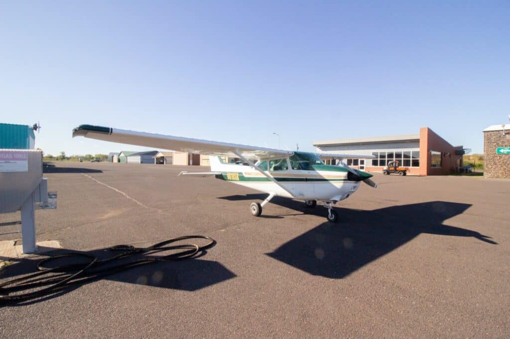 The green-and-white Cessna 172 N616SK parked on the ramp at KSUW.